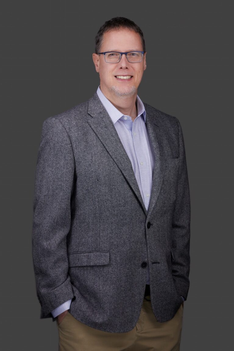 A waist-up image of Dr Cusic